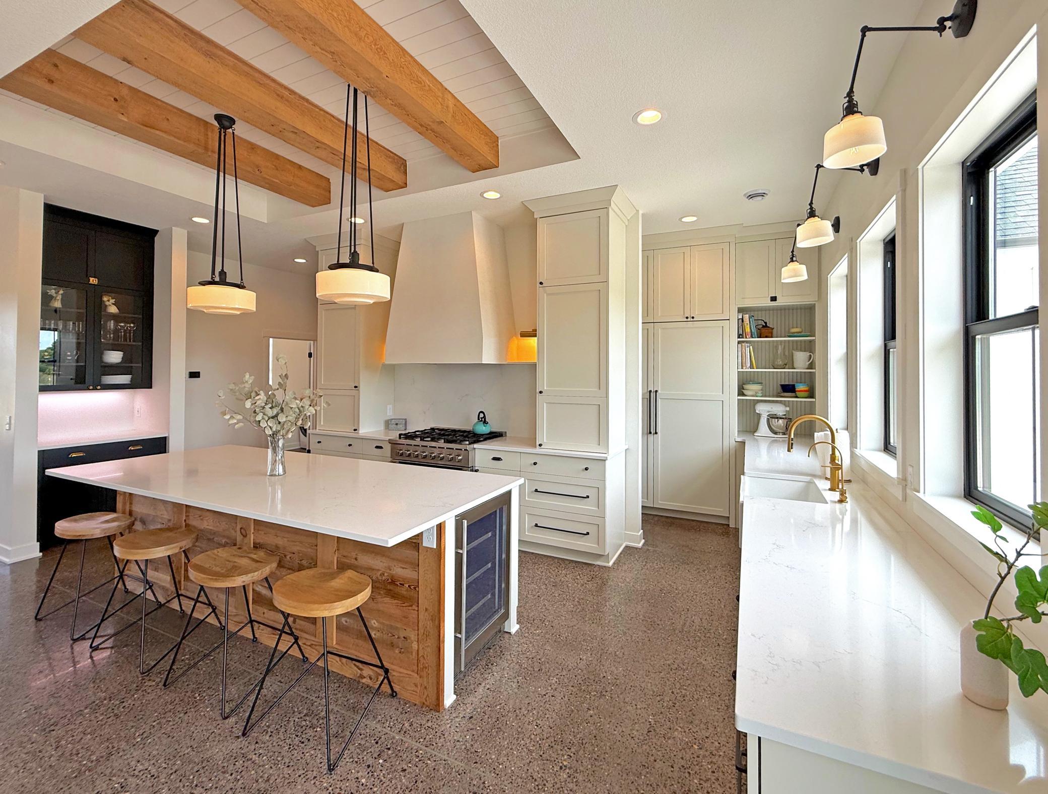 Stunning refrigerator and freezer have integrated columns with custom panels on the front to match the cabinetry combine beauty and functionality, creating an ideal setting.