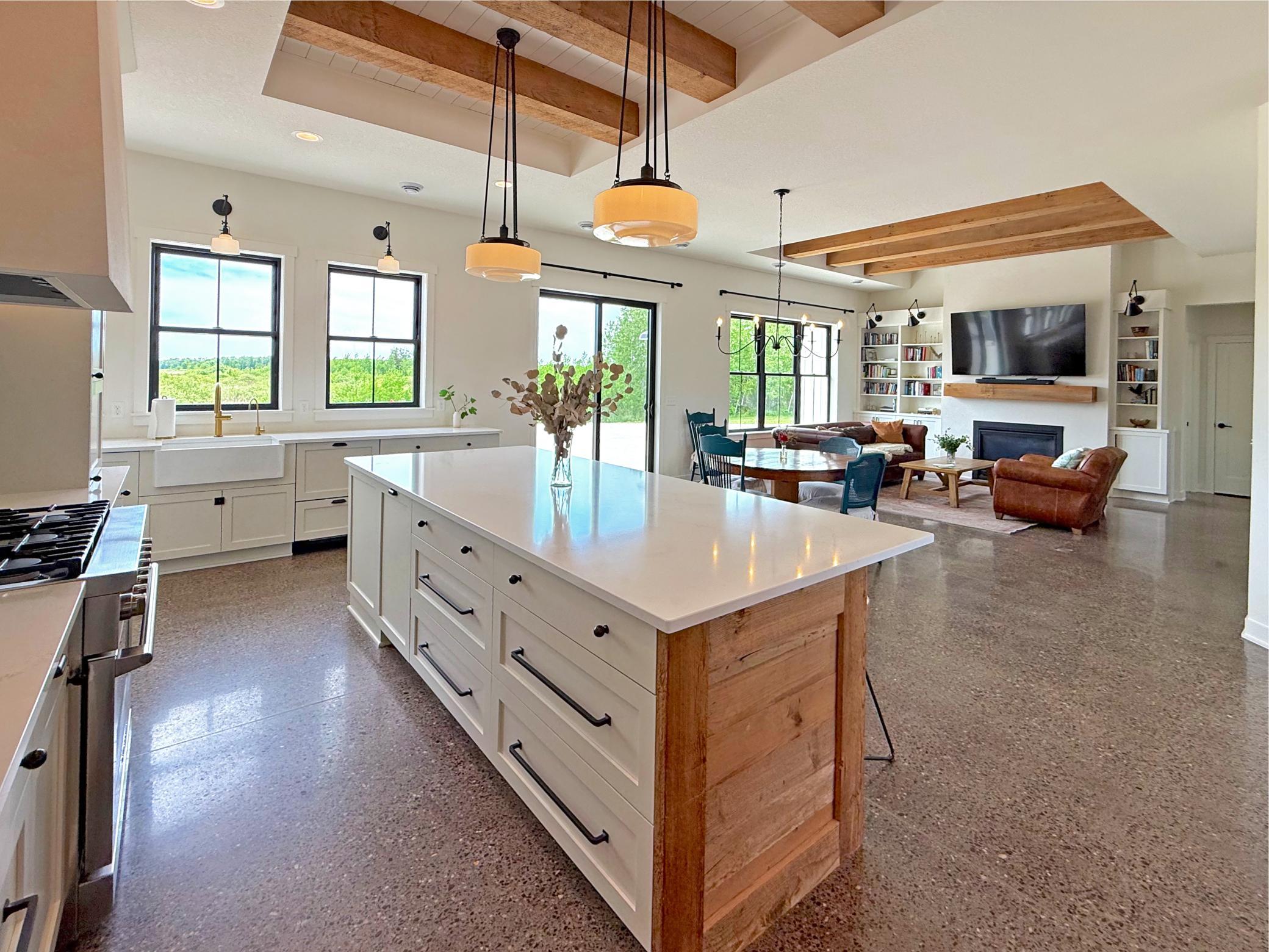 The gourmet kitchen is highlighted by a stunning center island wrapped in reclaimed wood, creating a warm and inviting focal point for gathering and entertaining.