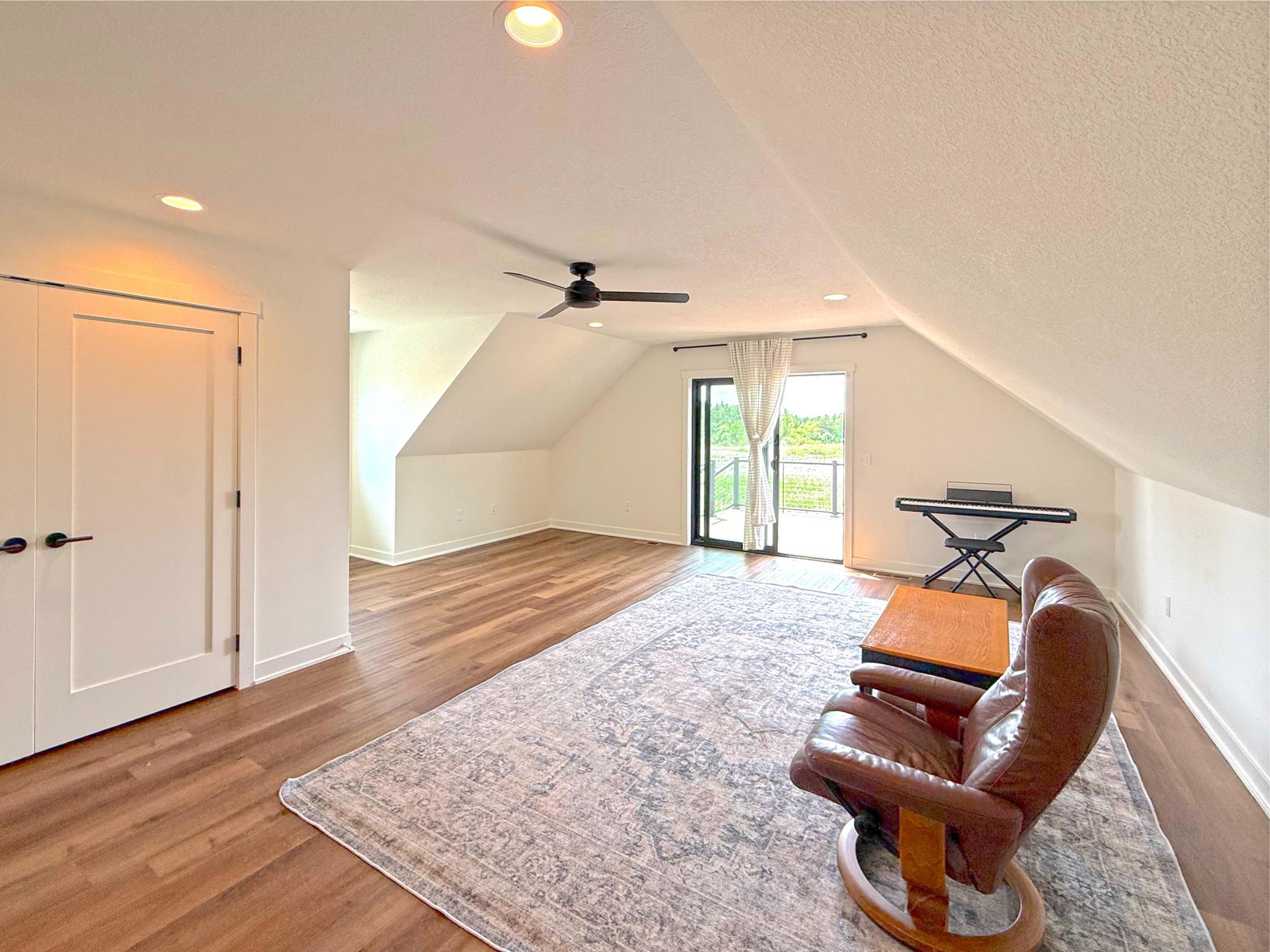 The upper-level family room provides a versatile retreat with abundant of comfortable space for relaxing, entertaining, or recreation.