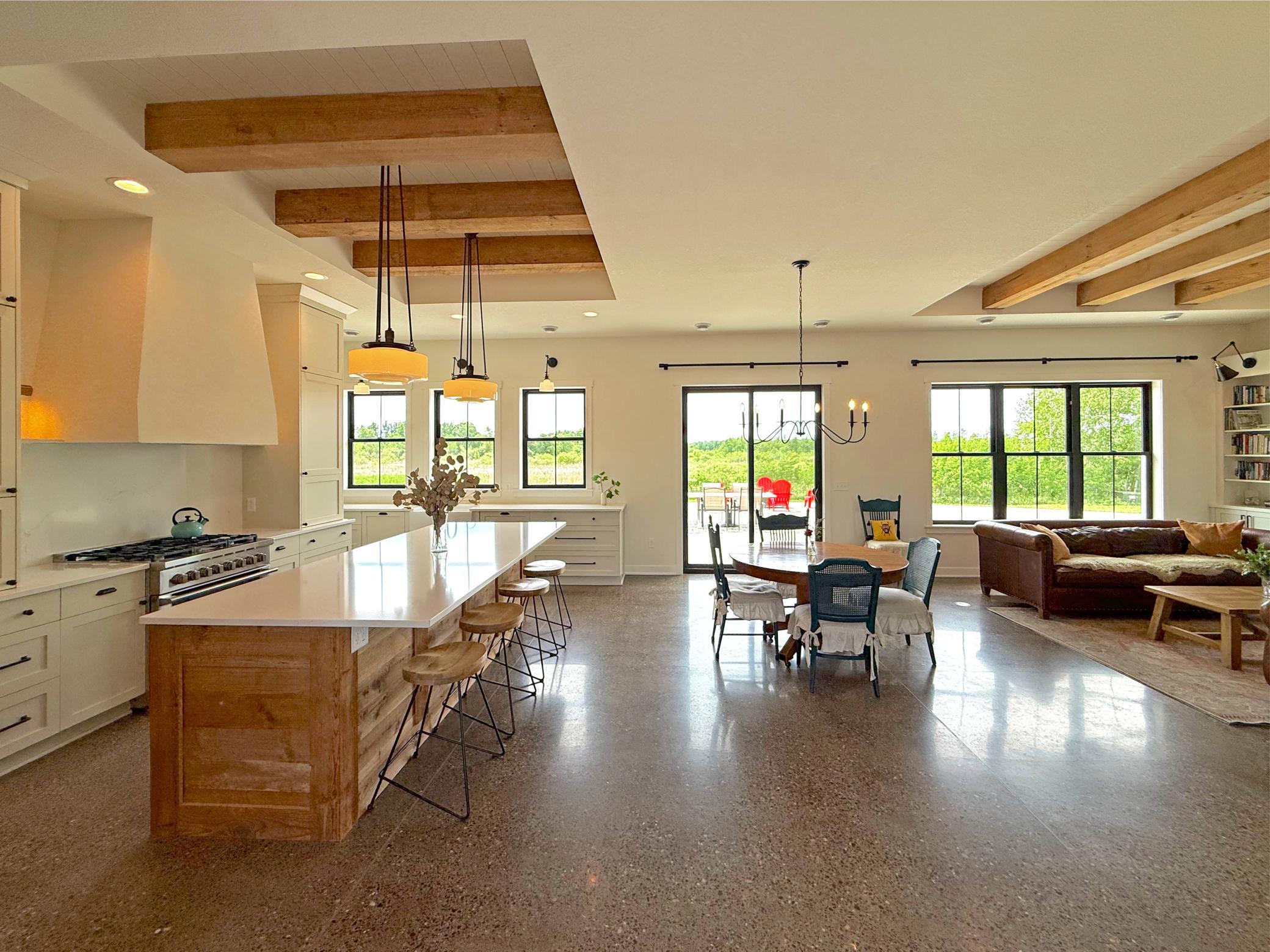 The heart of the home is the stunning open-concept living space, where the gourmet kitchen, dining area, and living room come together.