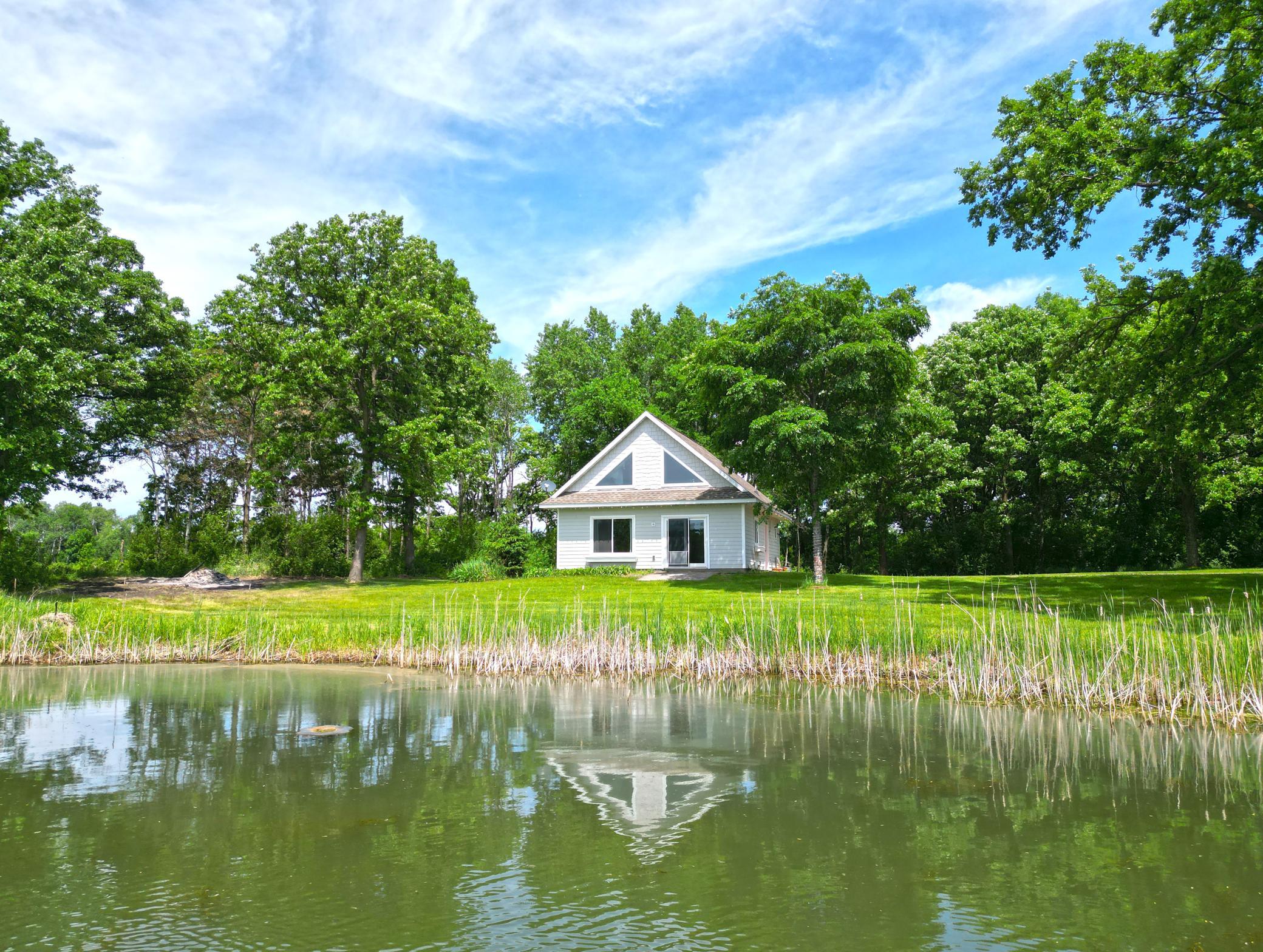 26x32 bunk house was built in 2012 offering 832 square feet on the main floor and a spacious loft with picturesque views of the pond and countryside.