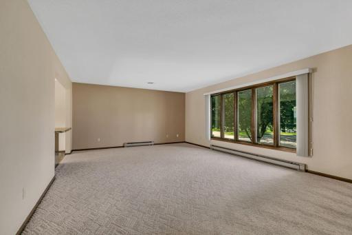 Very spacious living room off of the kitchen and dining. Full wall of windows let in natural light - and views of the lake.