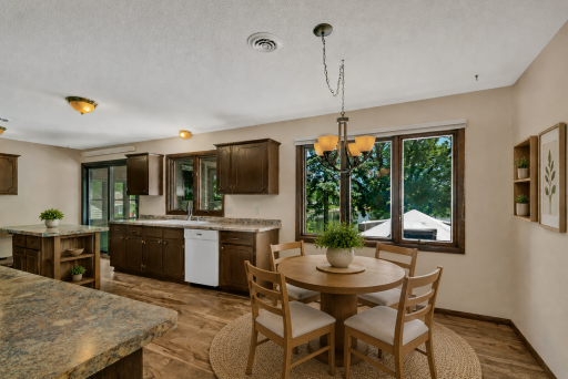 Dining with lake views - new flooring thoughout the kitchen/dining in 2019. Virtually staged