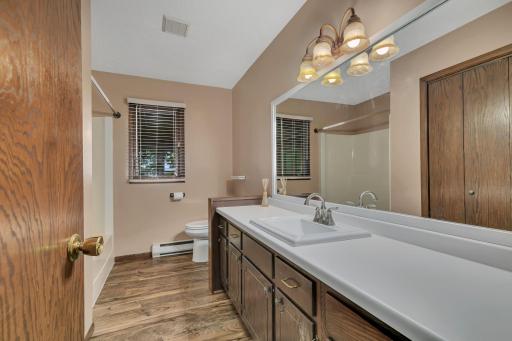 Ample counter space and storage in the upper level full bath.
