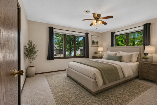 The primary offers lake views and natural light to help you relax after a day on the Course or the Lake - Virtaully staged