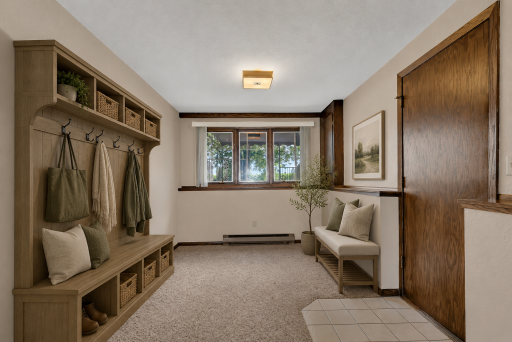 The perfect mudroom space off of the lower level garage entry. Access from the lake/backyard. Virtually staged