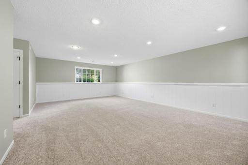 Large Look out windows in this large lower level living area