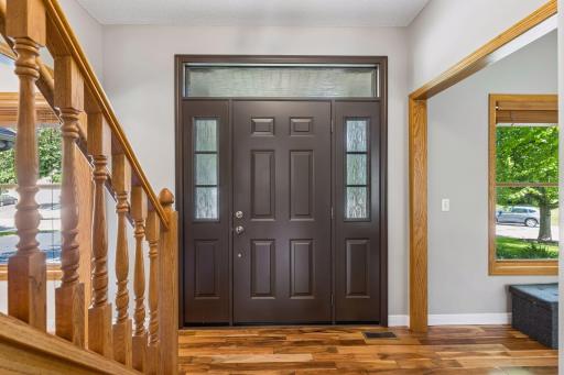 Stunning new entry door with sidelights and transom window. Rain glass allows light to fill the foyer while providing privacy and security.