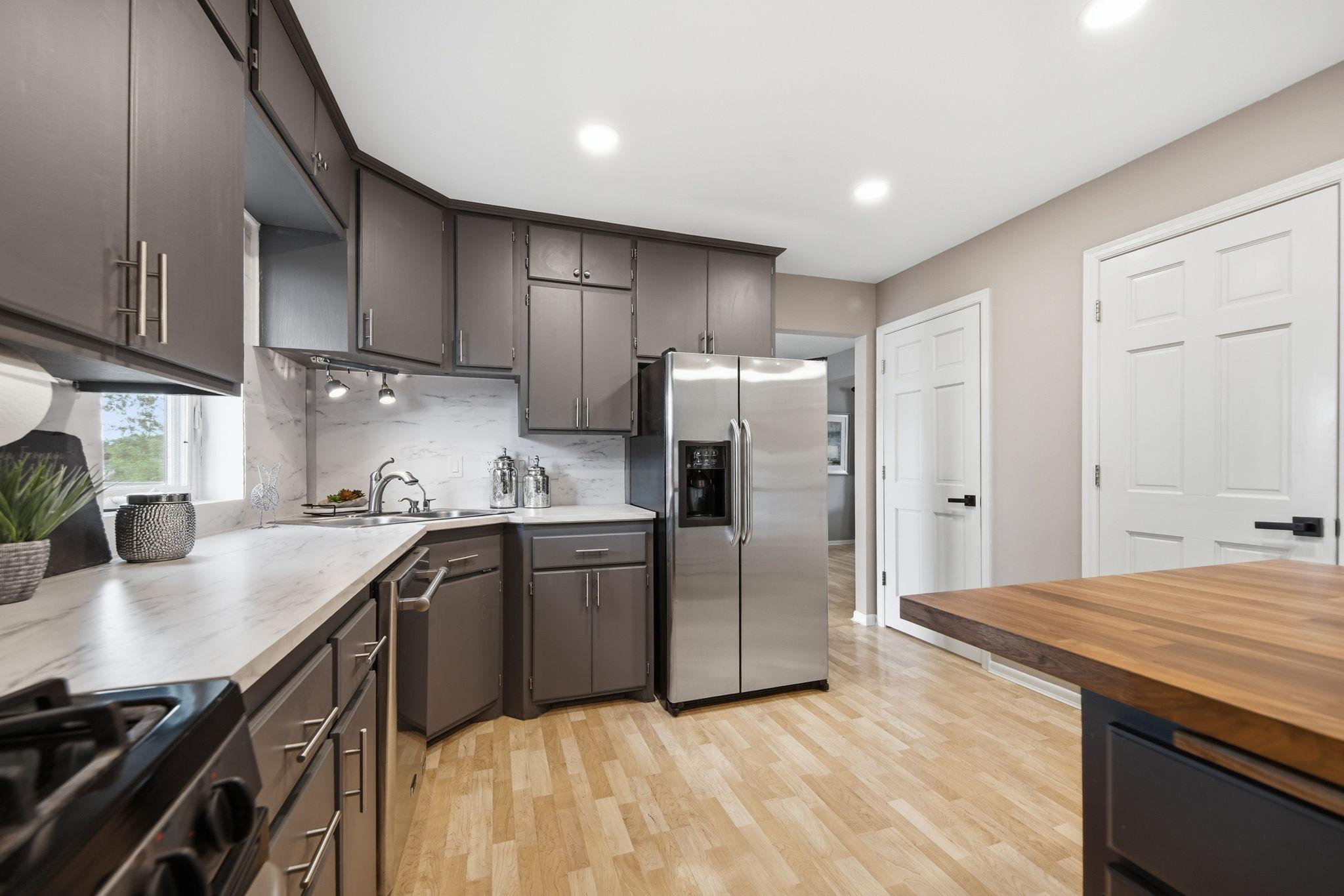 Stainless appliances and butcher block breakfast bar!