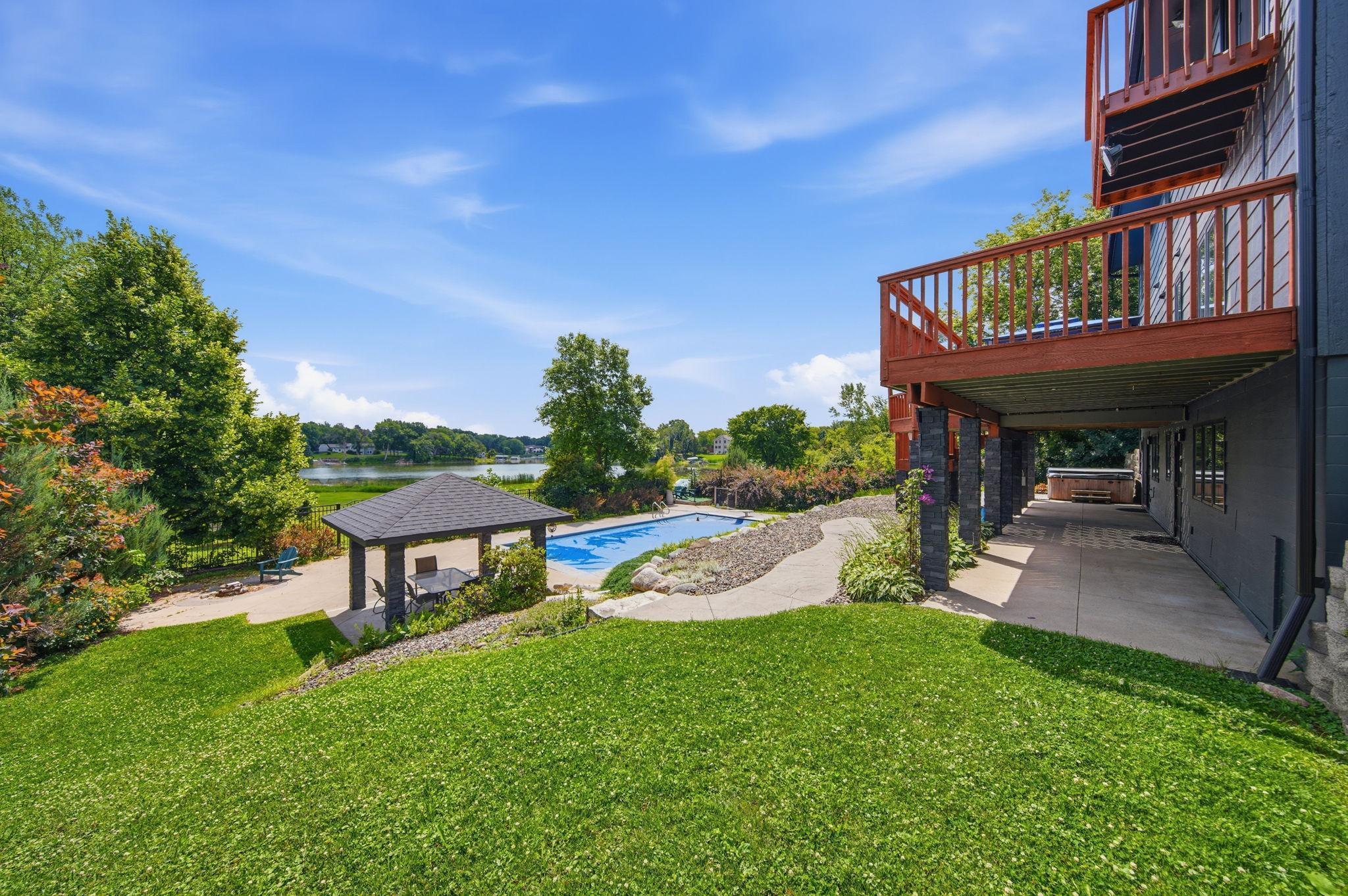 The backyard has been professional landscaped with a built in pergola, hot tub, and firepit area.