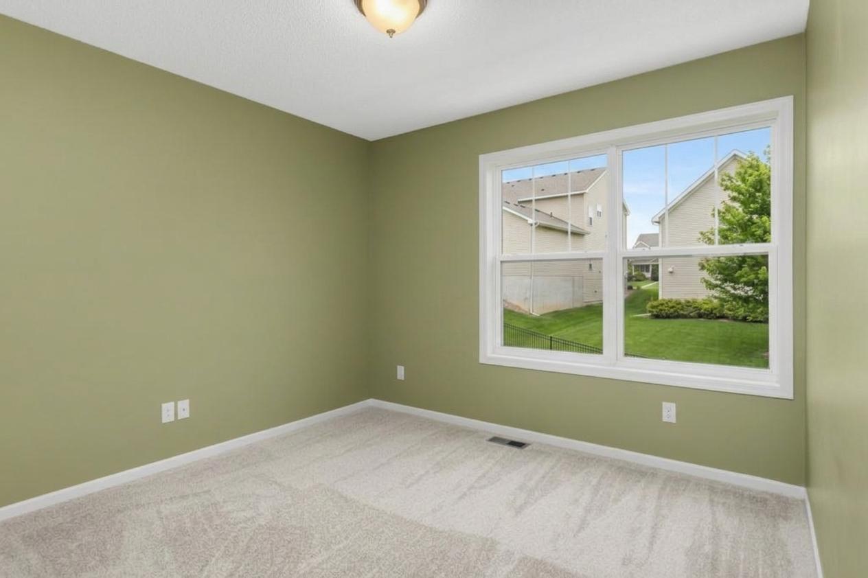 Well-sized secondary bedroom with neutral finishes and flexible use for guests, home office, or hobby space.