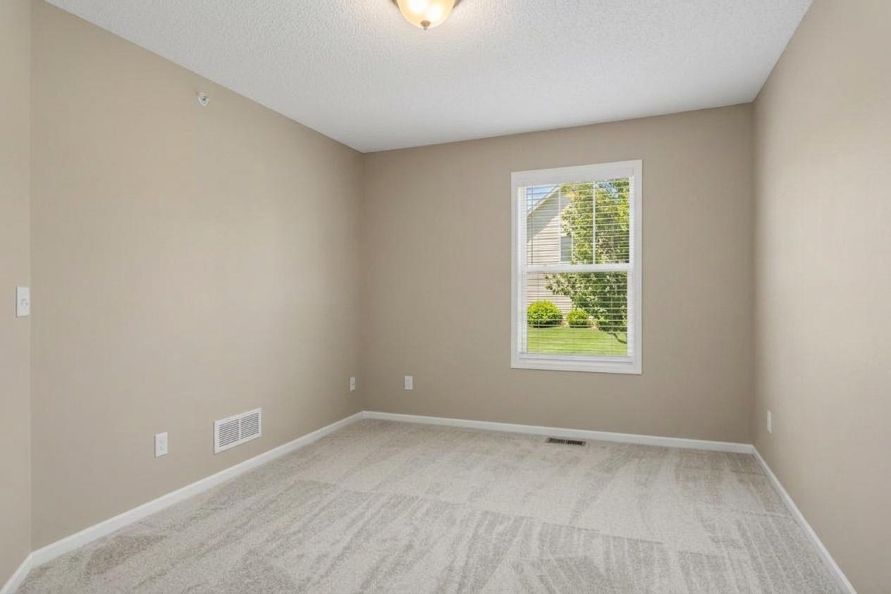 Additional upper-level bedroom offering comfortable living space and easy access to the full hallway bathroom.
