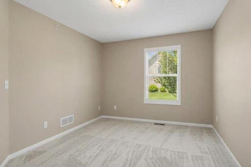 Additional upper-level bedroom offering comfortable living space and easy access to the full hallway bathroom.