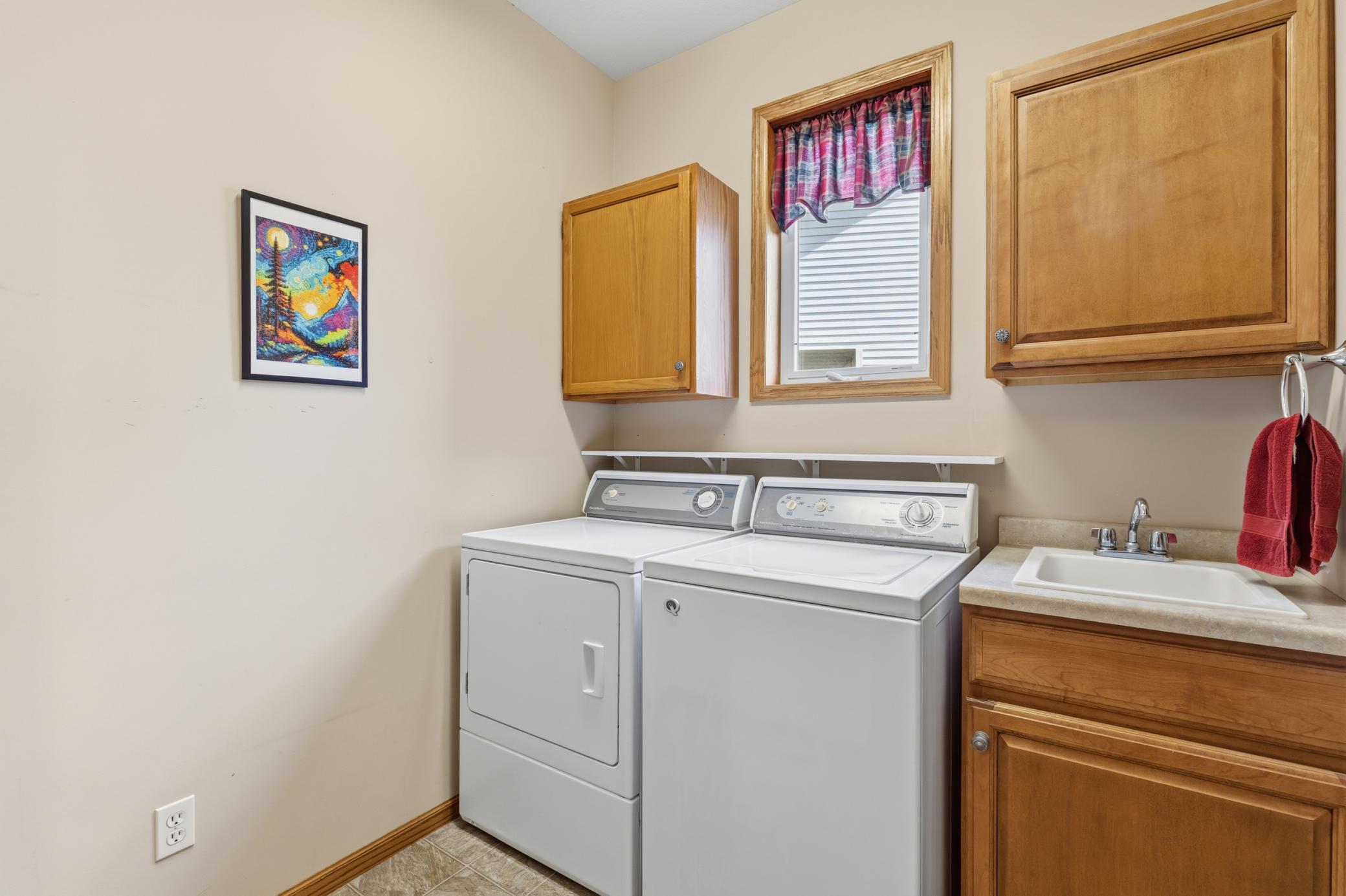 With its Speed Queen Washer and Dryer, Sink and Cabinets the Laundry Room is Just Steps from the Main Entrance, the Garage Entry and the Kitchen. Your New Home has "All Living Facilities on One Level."