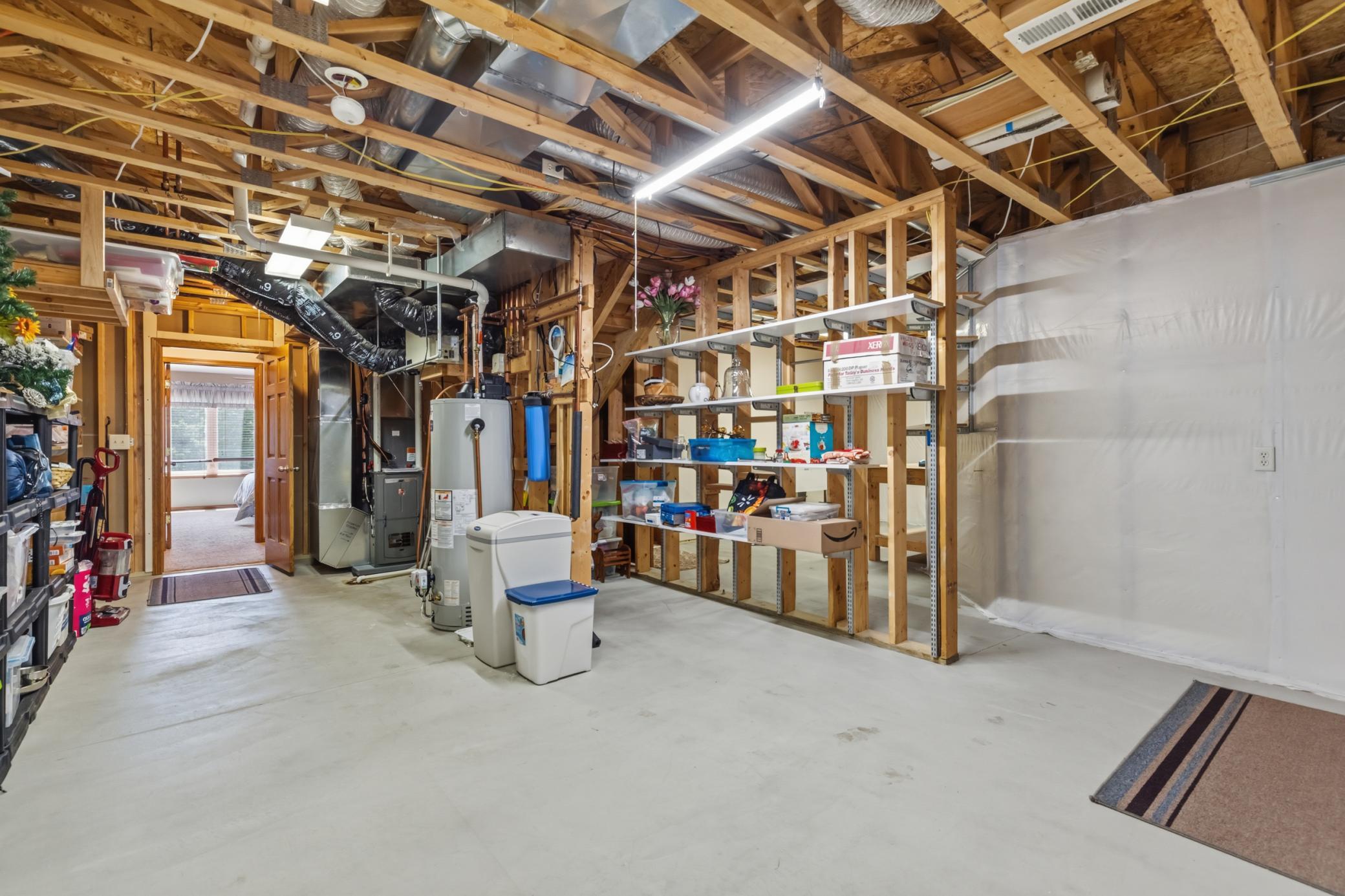 The Utility Area and Storage Room is 26x17 ft, with Bradford White Water Heater (2025), Water Boss Water Softener and Rheem Furnace (2025). Not Shown are the Rheem Air Conditioner (2025) and Sump Basket (in Foreground...no Sump Pump Ever Needed).
