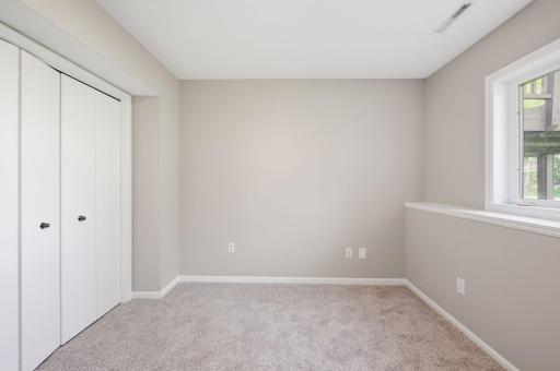 The 5th bedroom downstairs is adjacent to the living room and also has new carpet