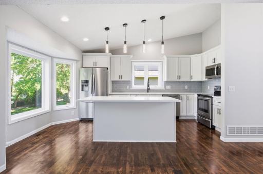 Beautifully styled kitchen with white shaker cabinets and expansive island