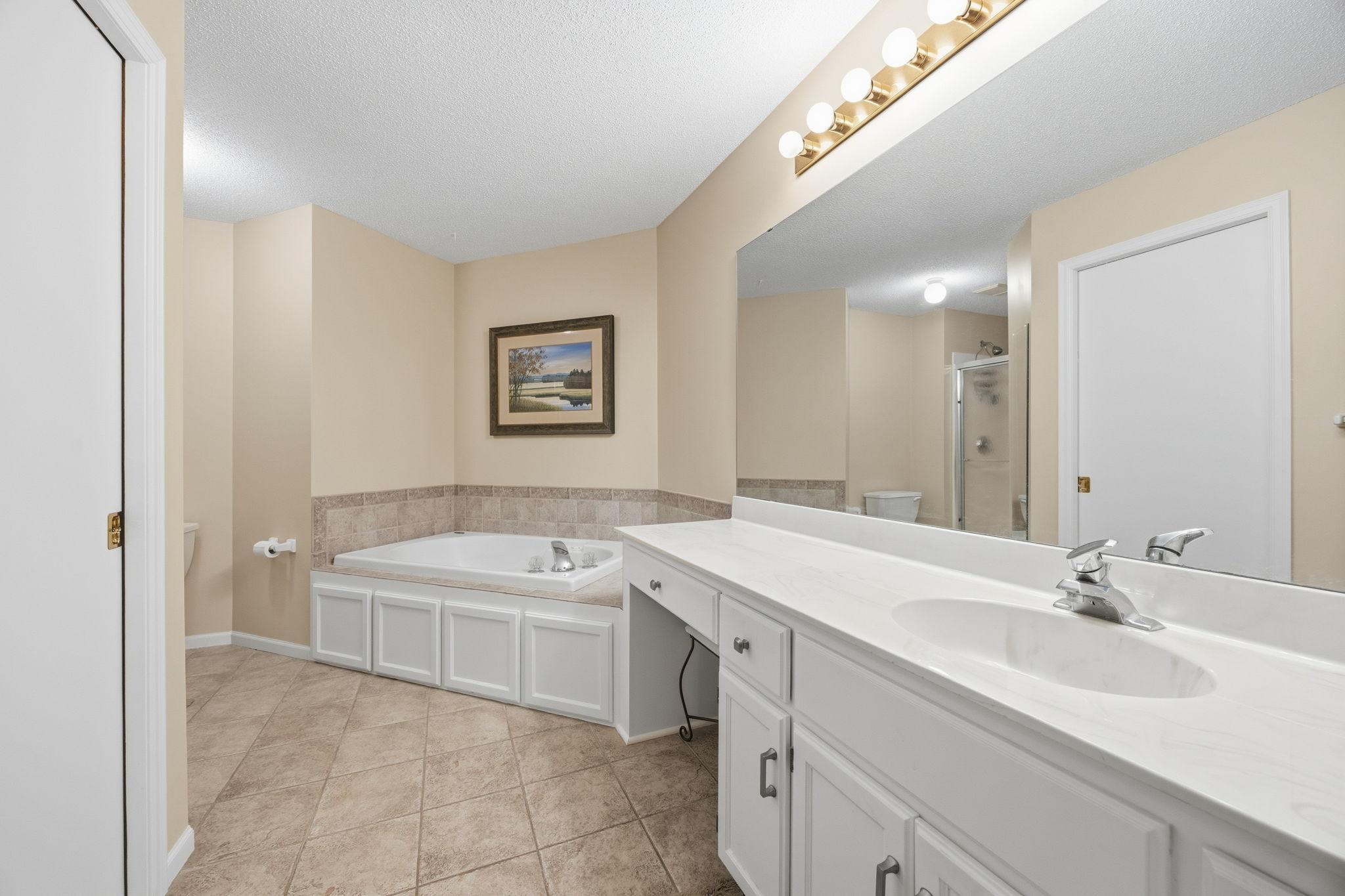 Primary ensuite with separate tub and shower