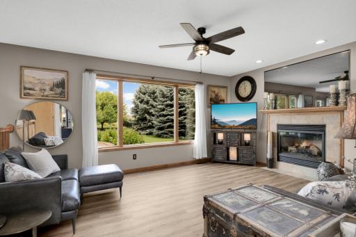 Beautiful Backyard Views! Relax in the spacious Family Room featuring a Gas Fireplace and large windows overlooking the private, landscaped backyard.