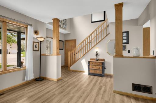 Open & Inviting! A bright foyer with soaring ceilings creates a welcoming first impression and opens to the flexible front living space.