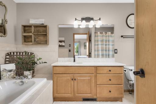 Private Owner's Bath with double vanity, soaking tub, separate shower, and updated Quartz countertops.