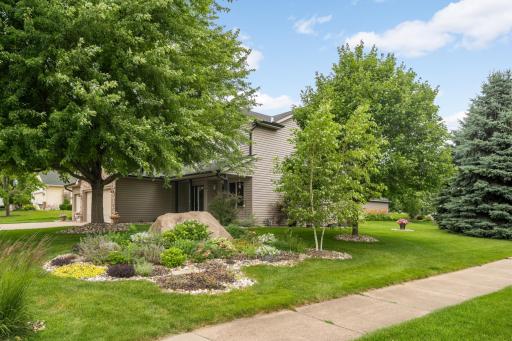 Front Exterior - Situated on a beautifully landscaped corner lot with mature trees, perennial gardens, and exceptional curb appeal.