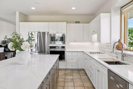 Freshly enameled cabinets, new quartz countertops, newer stainless appliances, new sink and faucet, efficient work triangle, light and bright!