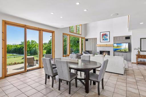 Informal dining features beautiful views of sweeping rear lawn and the potential to watch in the distance, as horses and riders, practicing their jumps.