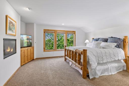 Spacious primary suite features gas fireplace and stunning pastoral views.