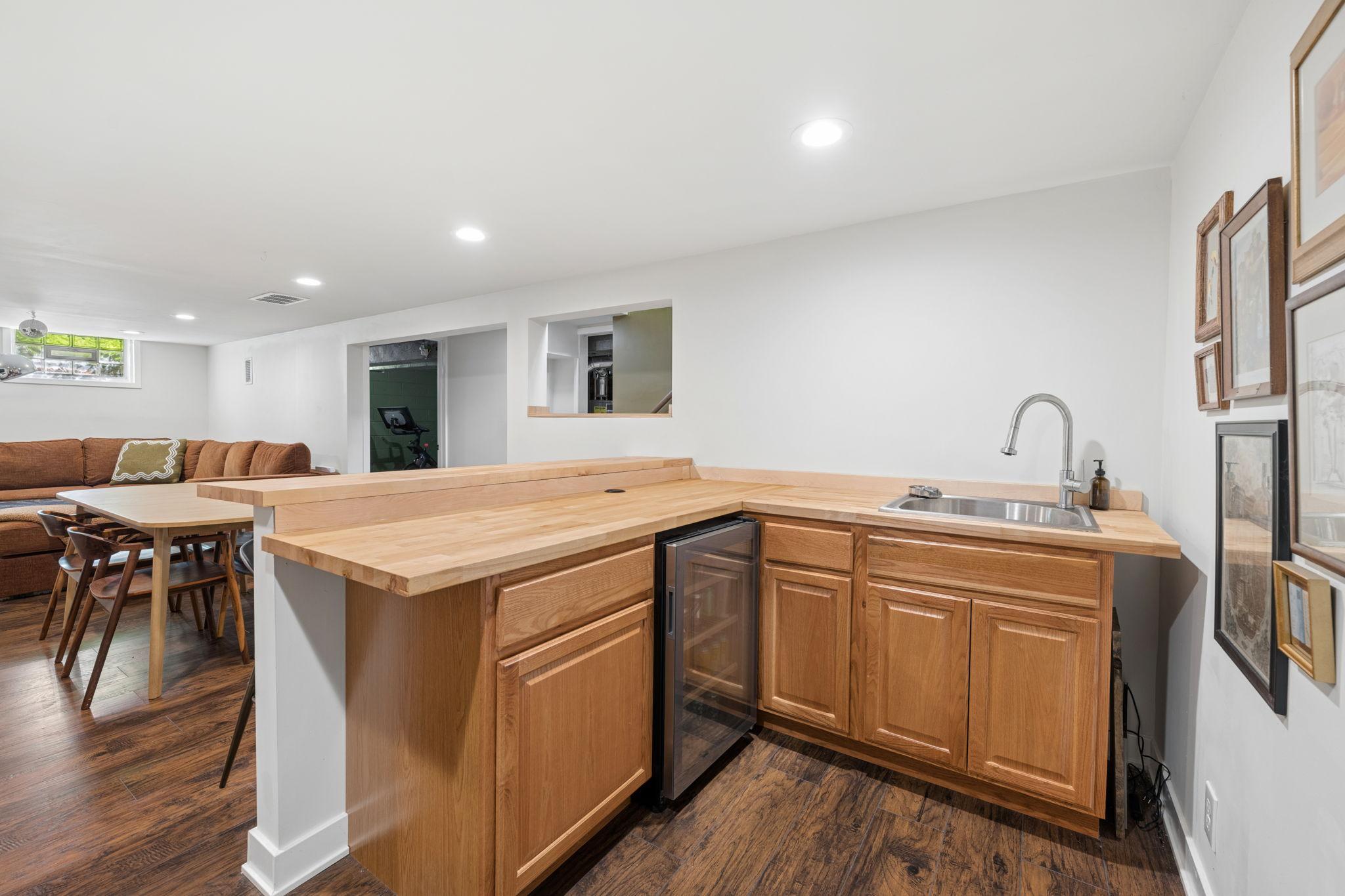 Built-in bar with mini fridge. The sink also has a glass washer!