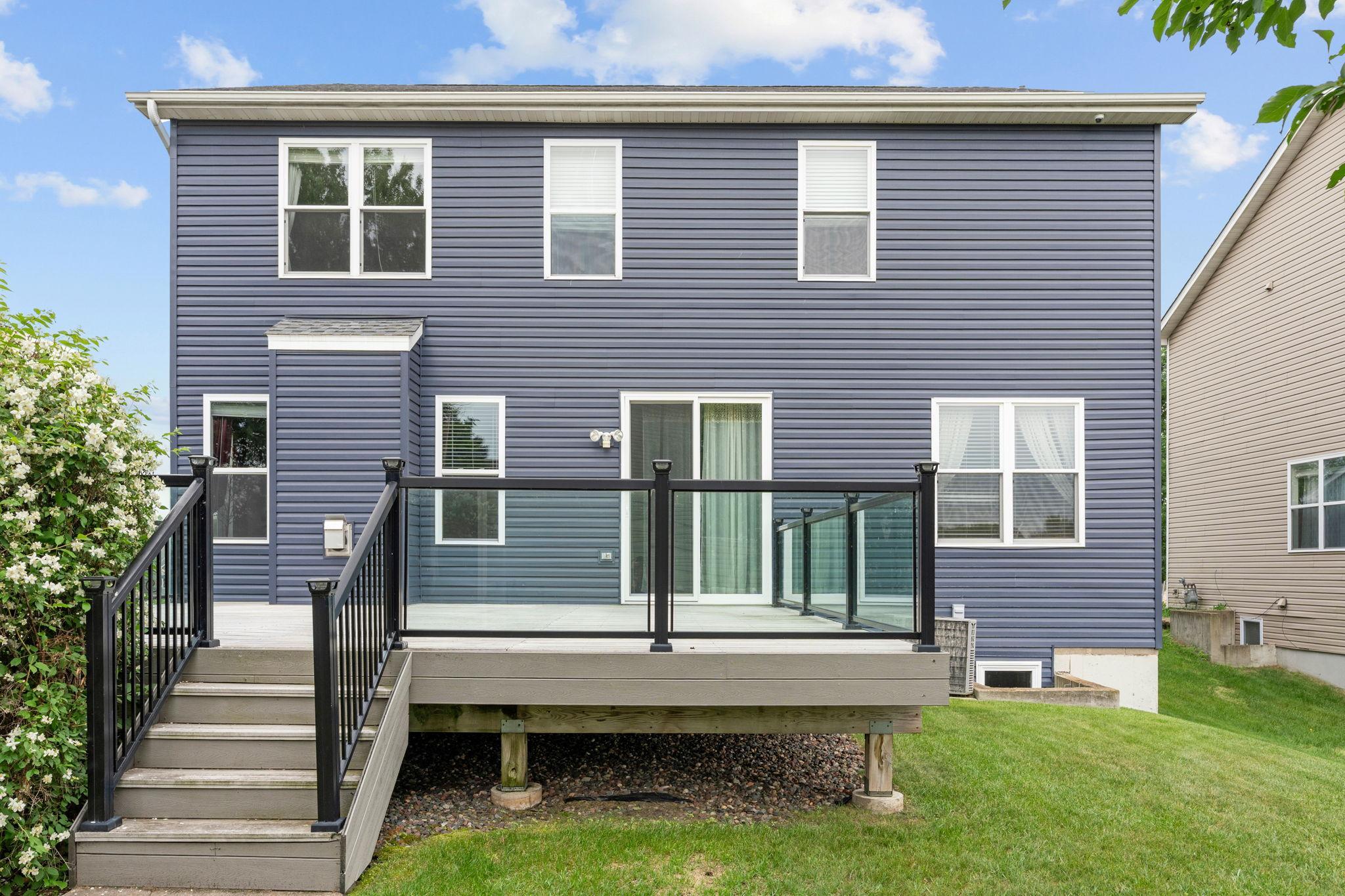 Large deck overlooking nice flat yard.