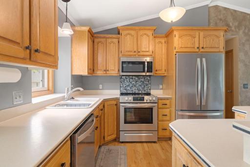 Ample storage, stainless steel appliances, center island and tile backsplash make this kitchen a dream!