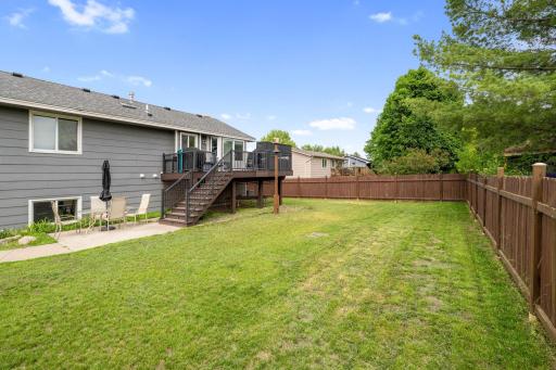 Step outside to your own backyard oasis: a huge, privacy-fenced yard with a concrete patio, & storage shed.