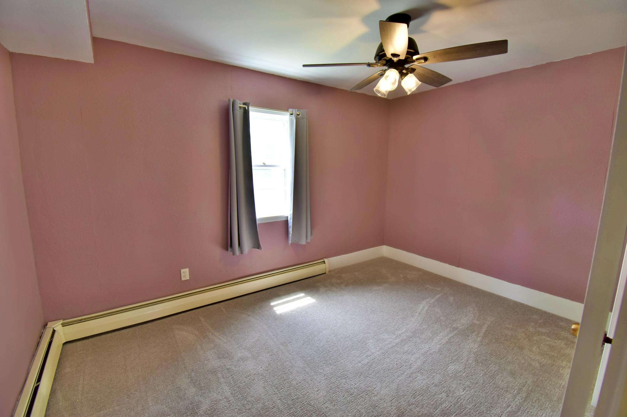 Main floor bedroom, up by the front door, features brand new carpeting!