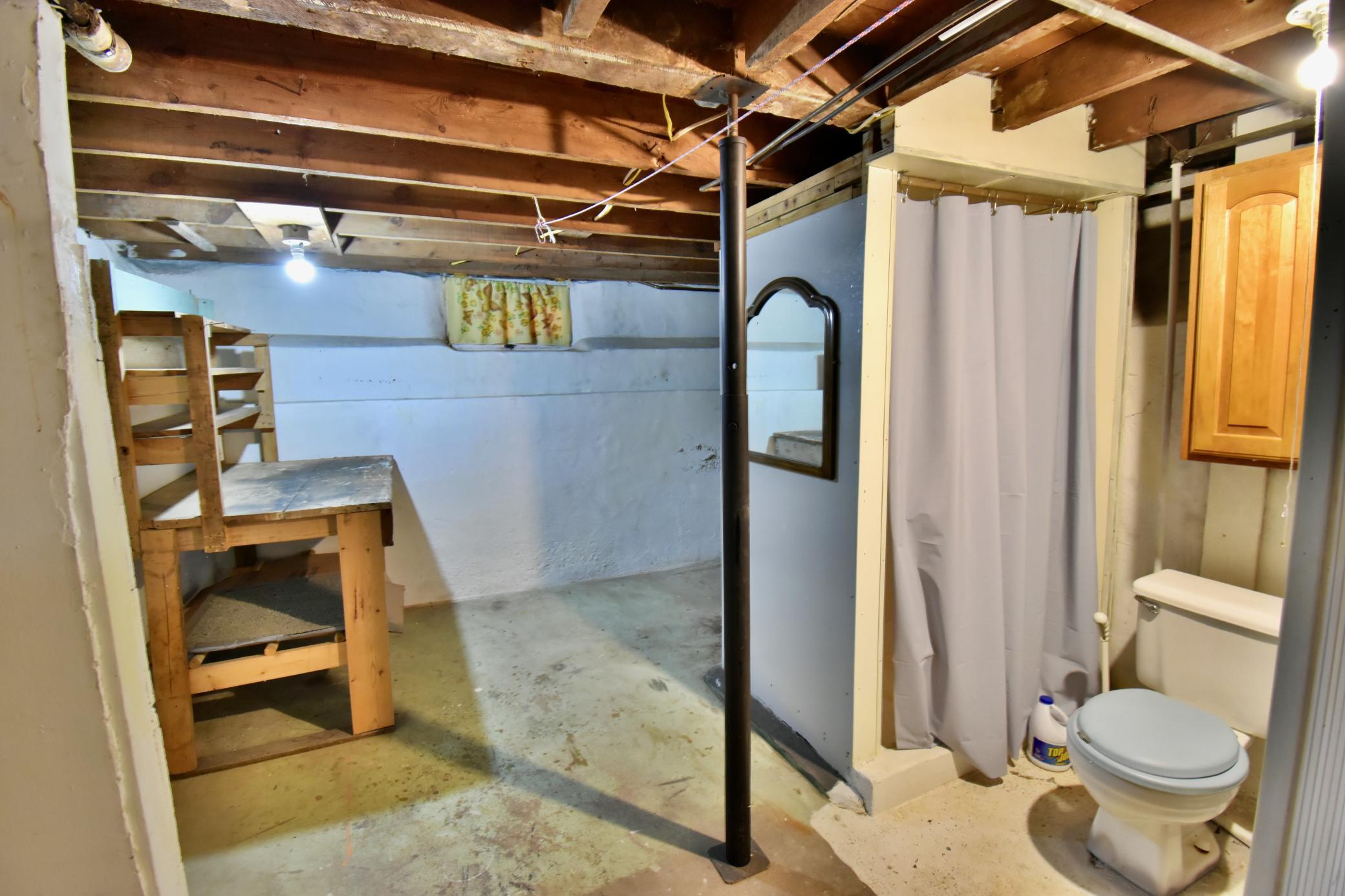 Lower level has a half bath and a workshop area!