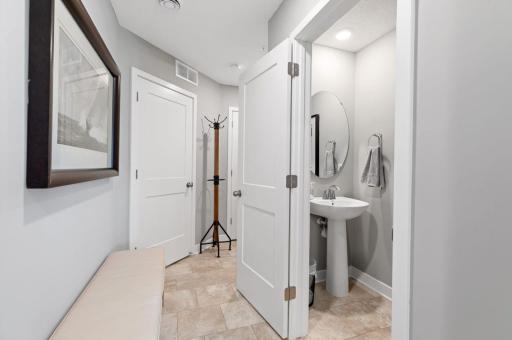 (Photo of a decorated model, actual homes finishes will vary) Conveniently located powder bath on the main level.