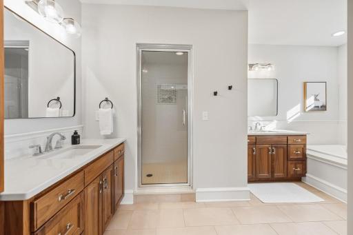 Two vanities provide room to move through the morning with ease, while dedicated linen storage keeps everything organized and within reach.