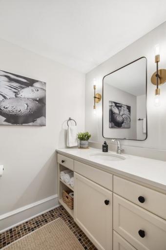 Bright and thoughtfully appointed, the shared upper-level bath offers a fresh, functional space designed to serve both bedrooms with ease and style.