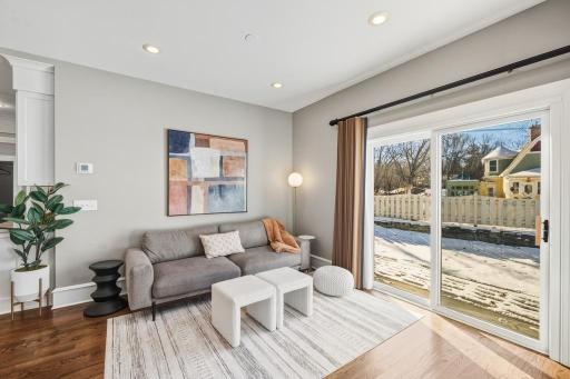 The living room sets the tone with warm hardwood floors and an easy, open feel.