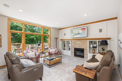 Living Room with gas fireplace, new carpet & views of the pretty backyard.