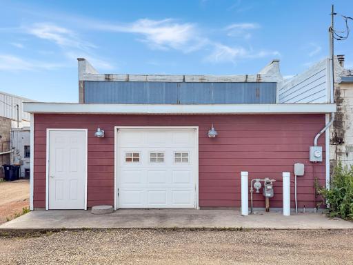 Back of building, overhead garage door into storage area behind the theater