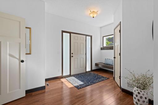 Inviting front entry featuring hardwood floors, abundant natural light, and an open layout that creates a warm first impression.