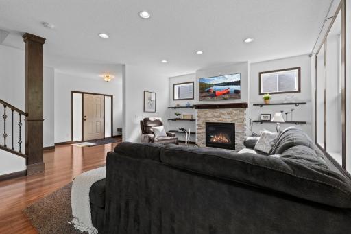 Bright and comfortable gathering space highlighted by fresh paint, beautiful woodwork, and a cozy gas fireplace.