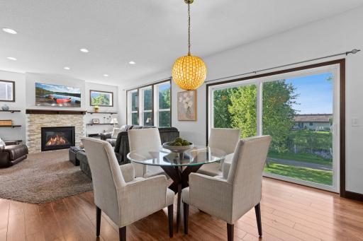 Sun filled dining area surrounded by windows, offering beautiful backyard views and flexible space for everyday meals or entertaining guests.