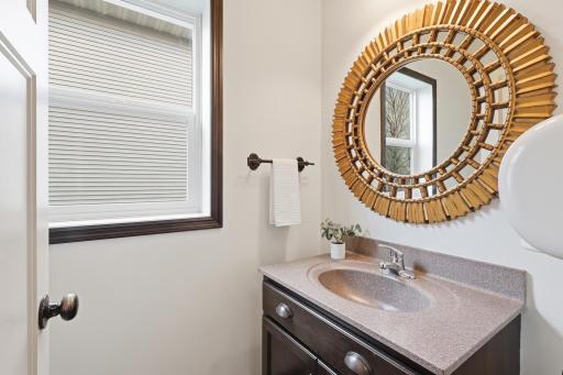 Convenient main level powder room featuring updated finishes and easy access for guests.