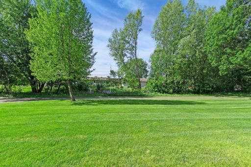 Enjoy a spacious flat backyard backing to mature trees and a scenic walking path, offering privacy, green space, and room to play, entertain, or relax.