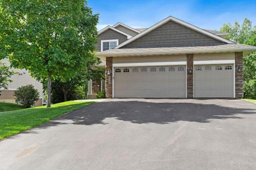 Beautiful curb appeal with a 3 car garage, freshly sealed driveway, and welcoming front elevation in a desirable Lakeville neighborhood.