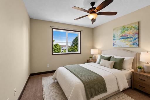 Generously sized upper level bedroom with large window, neutral finishes, and ample space for family, guests, or a home office.
