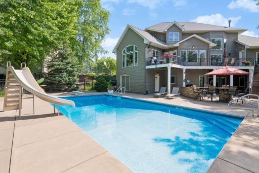 Something for everyone here to enjoy in this backyard. Eat and drink by the grill station, swim, sit on the upper deck and watch it all or relax in one of many seating areas poolside.