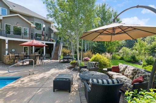 Backyard offers lush green space as well for garden with multiple seating areas to take it all in. Upper deck access from primary suite and access points from kitchen